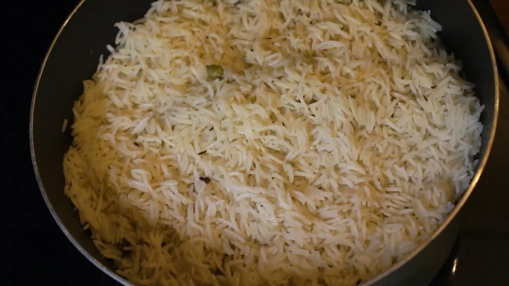 Adding another layer of rice to make pakistani biryani