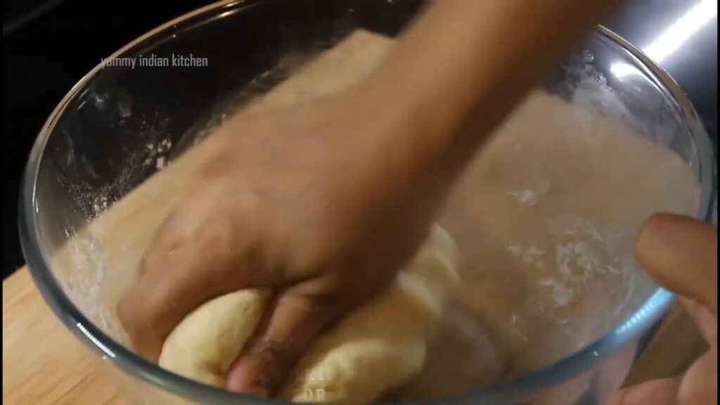 Kneading it well to make a soft and pliable dough