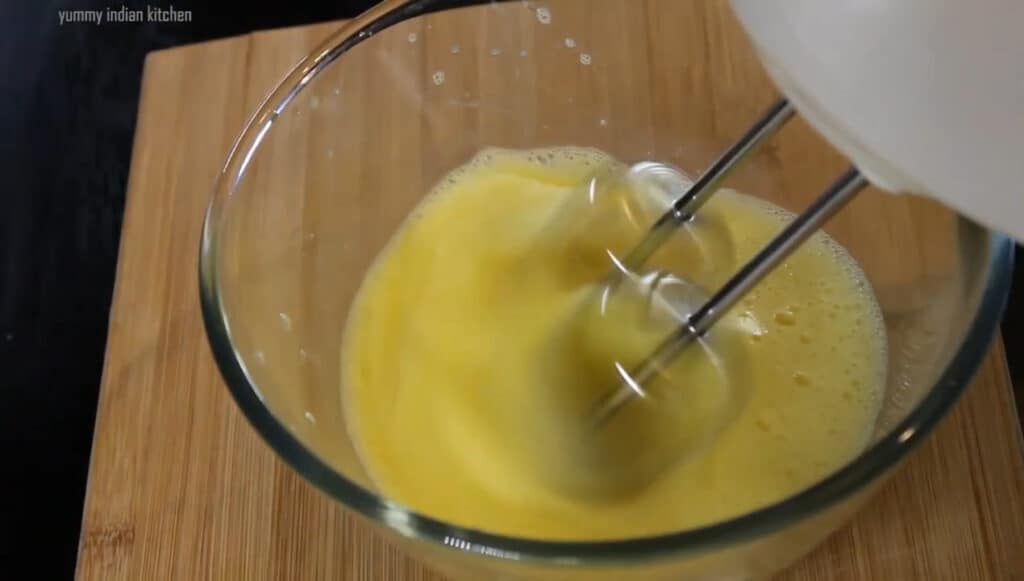 adding the eggs and whisking them well