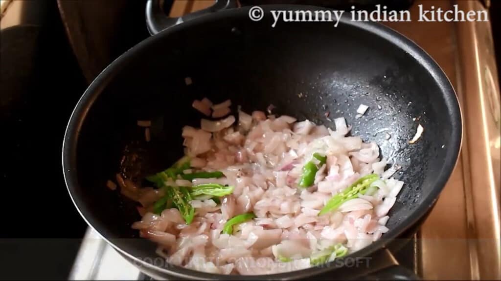sauteing chopped onions and slit green chillies
