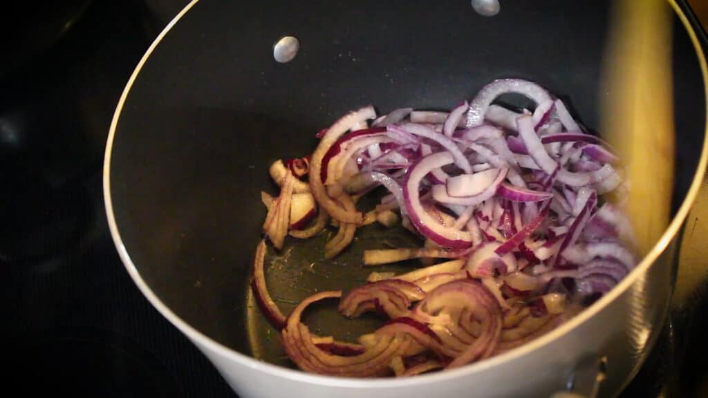 adding finely sliced large onion and sauteing the onions