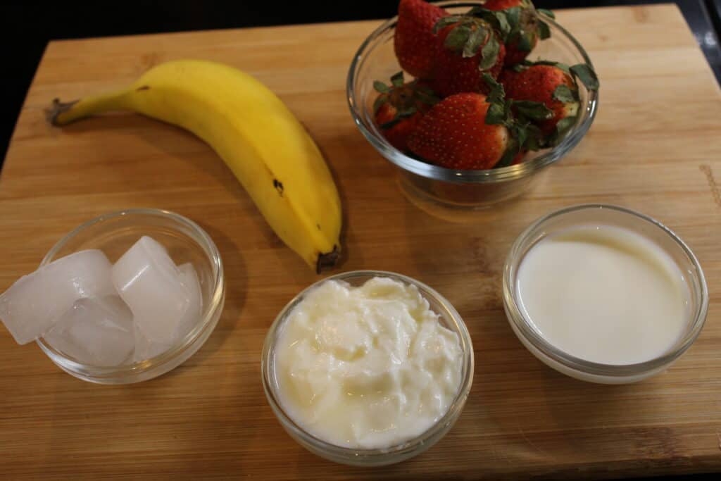 ingredients displayed to make Strawberry Banana Smoothie with yogurt