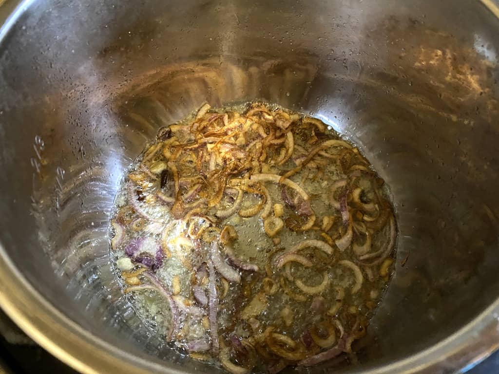 adding whole spices and onions
