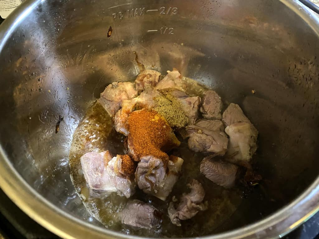 Adding 500 gms of lamb/ mutton pieces