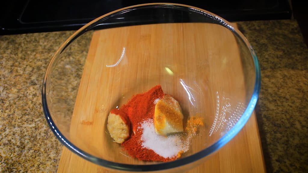 adding marinating spices to a bowl
