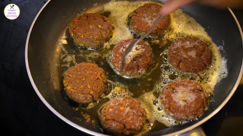 flipping and cooking the shami kabab