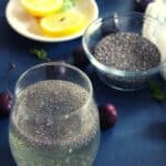 chia seeds weight loss drink served in a glass with lemon slices and chia seeds beside