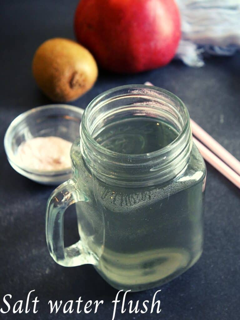 salt water in small jar with pink salt placed beside