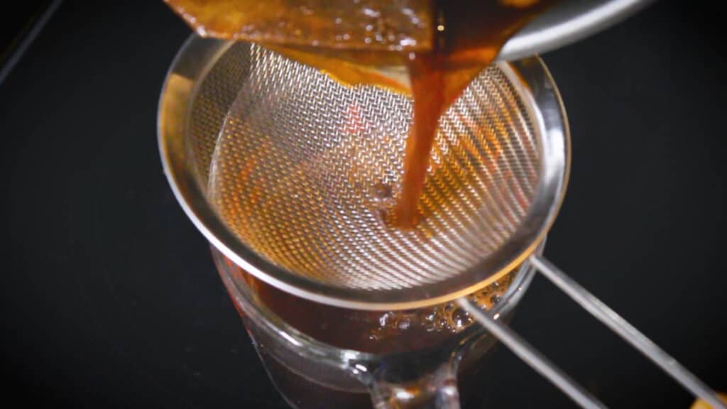 straining the chai concentrate