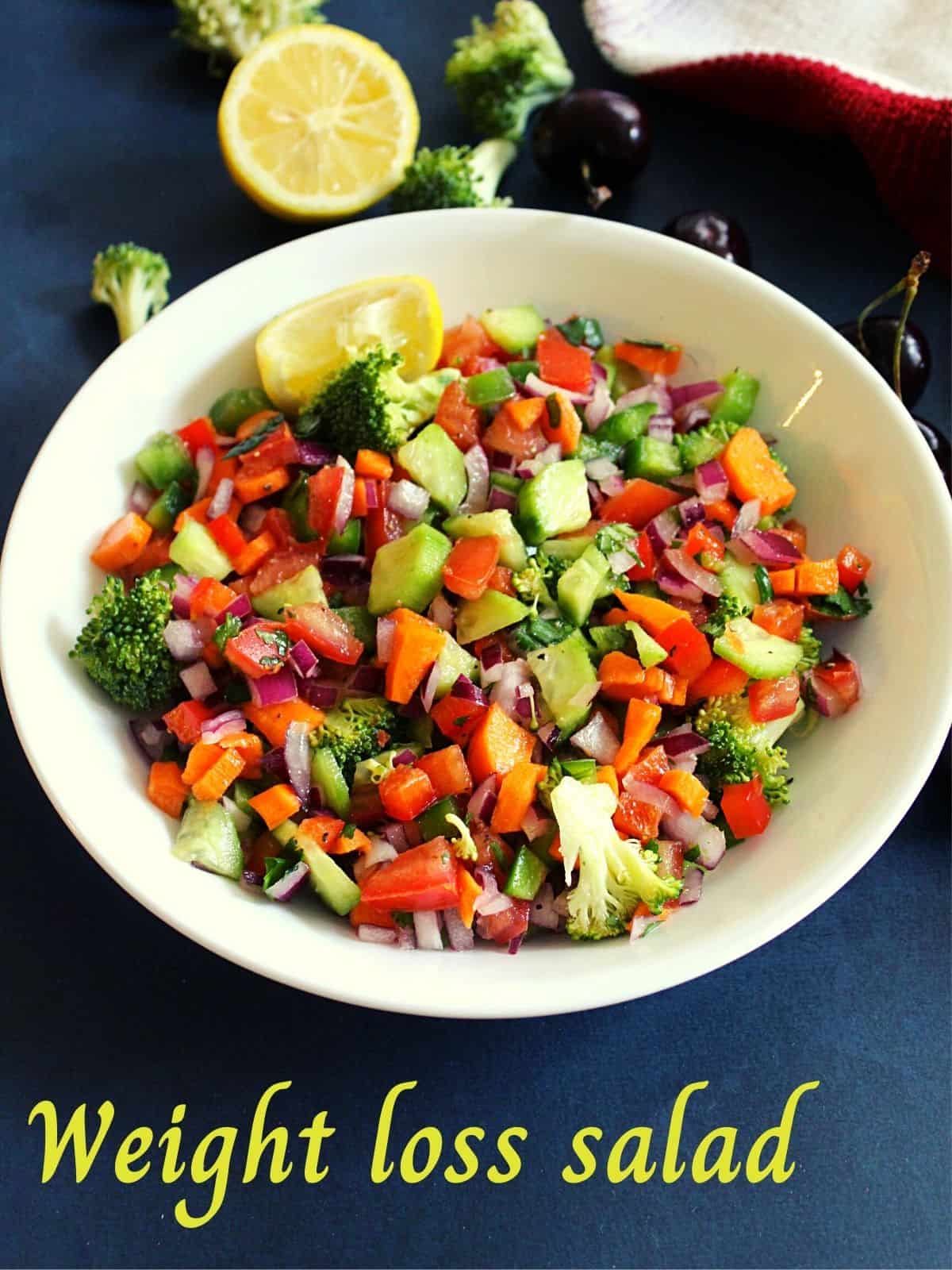 weight loss vegetable salad served in a bowl with lemon wedges placed beside