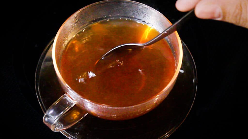 stirring the weight loss black tea before serving.