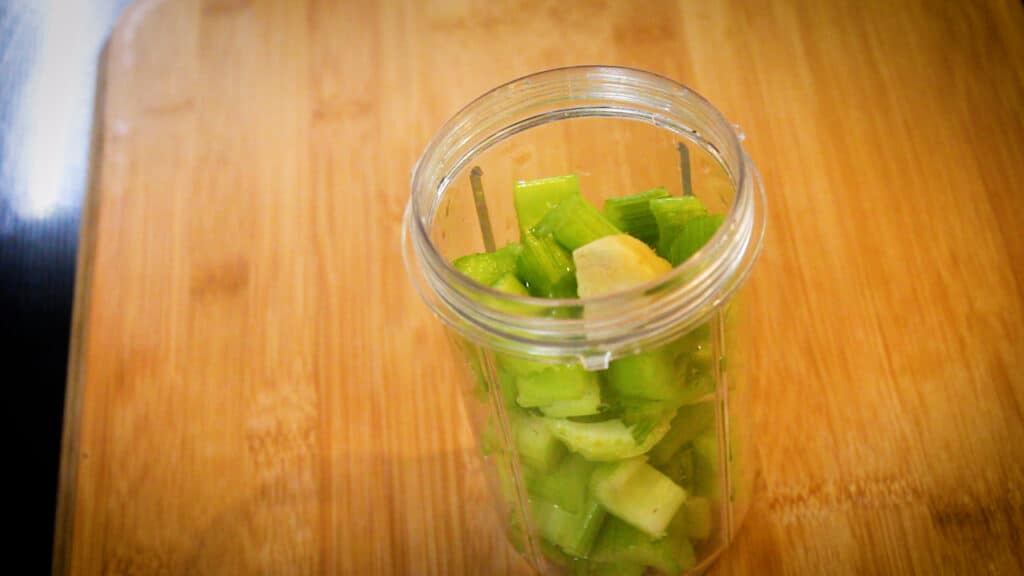 adding celery and ginger in a jar