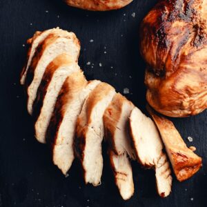 baked chicken cut into slices on a board for weight loss diet
