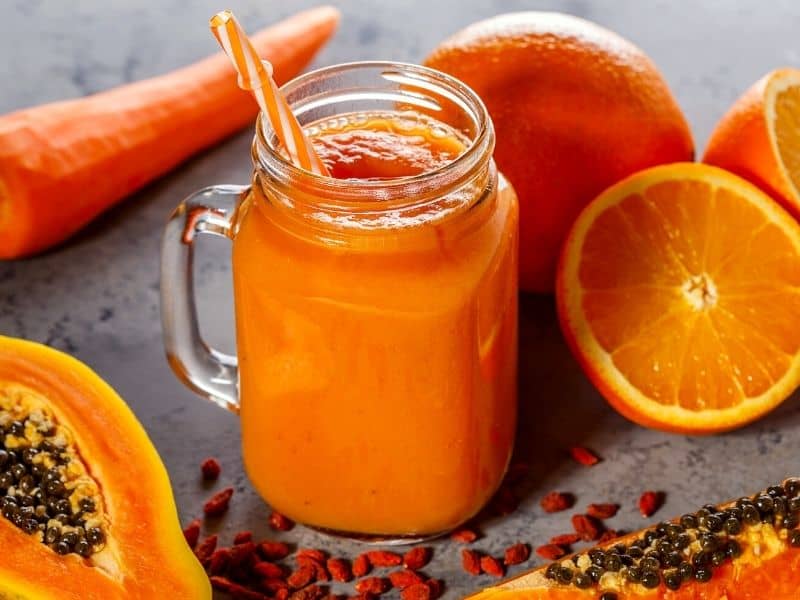 papaya detox smoothie for weight loss with oranges and papaya placed aside 
