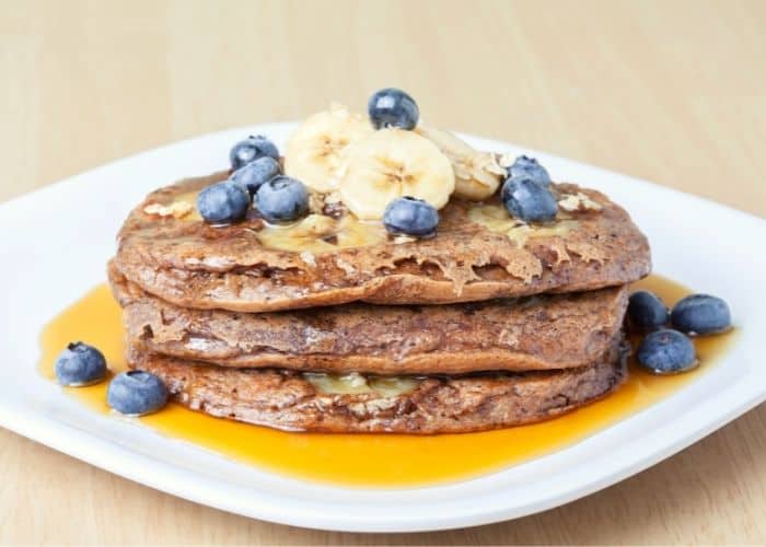no egg pancakes with blueberries and banana on top as low carb breakfast without eggs