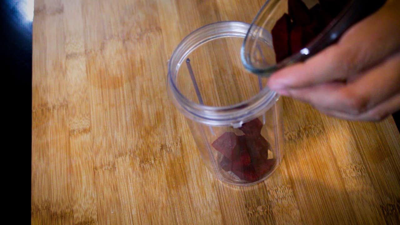 adding chopped beetroot to the jar