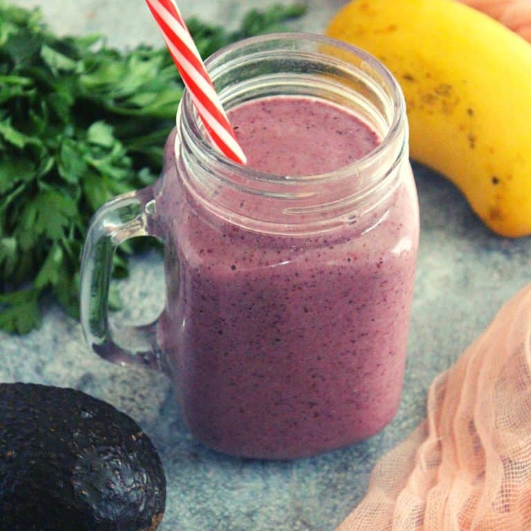 weight loss breakfast smoothie in a mason jar with avocado and greens shown as garnishing