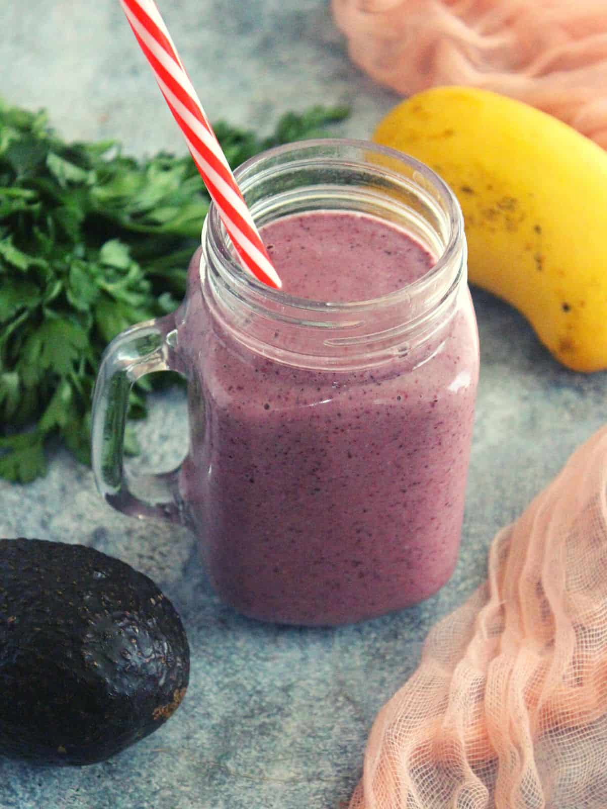 weight loss breakfast smoothie in a mason jar with avocado and greens shown as garnishing