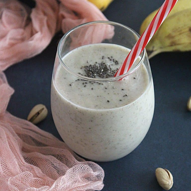 weight loss banana smoothie in a glass with mango and banana on the background