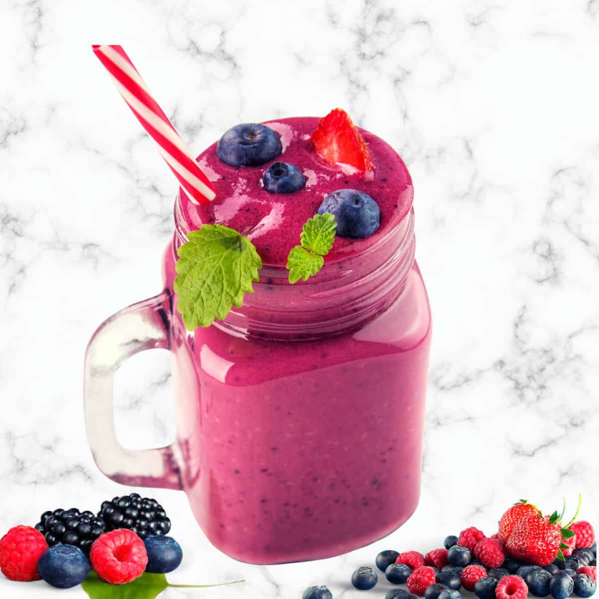 frozen fruit smoothie in a mason jar made using berries and served with a straw