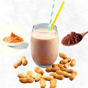 Peanut butter smoothie without banana in a glass with peanuts and cocoa powder and nut butter around the glass