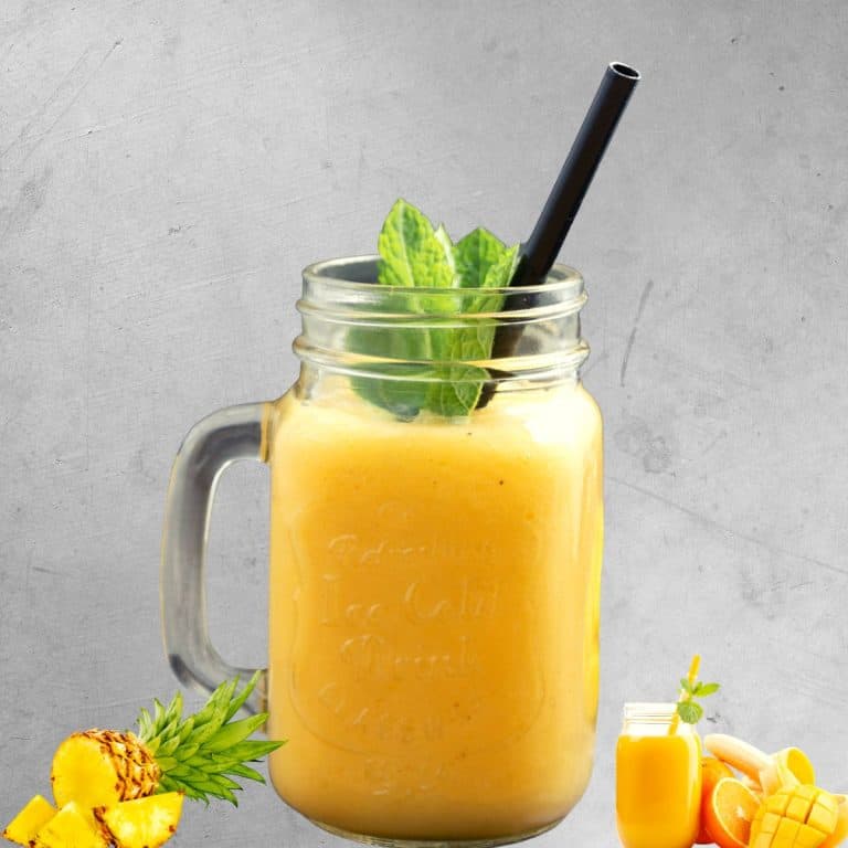 healthy pineapple smoothie in a mason jar with pineapple placed beside