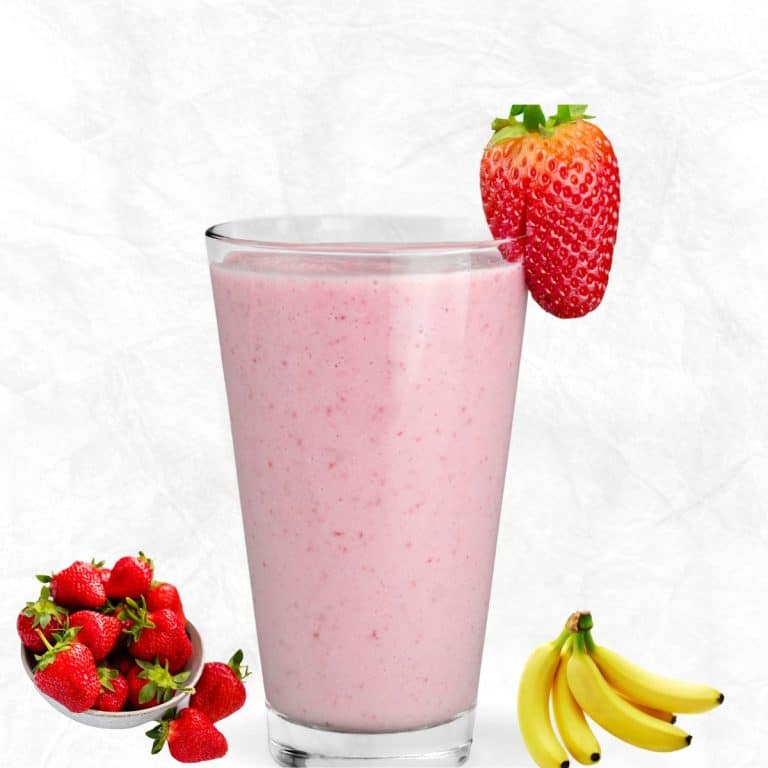 strawberry banana smoothie with yogurt in a glass with a strawberry topping and the fruits placed beside the glass