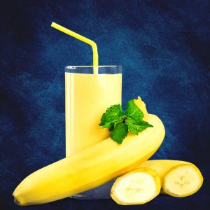 banana smoothie with milk in the glass with banana fruit beside the glass