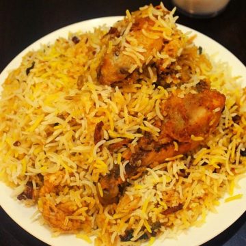 biryani with chicken made in oven is served on a plate
