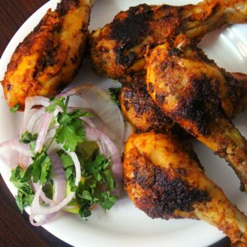 chicken legs or drumsticks fried and served on a plate