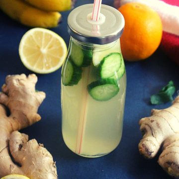 homemade drink to lose weight in a bottle with ginger, lemon around