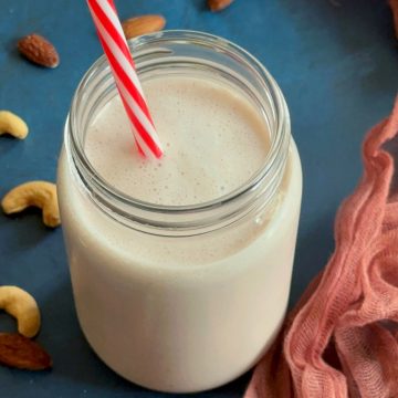 low carb smoothie with high protein ingredients in a mason jar with nuts garnished around