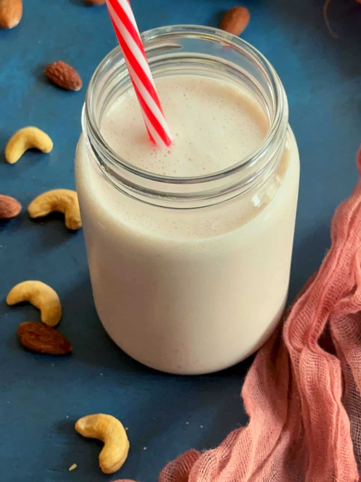 high protein low carb smoothie in a mason jar with nuts garnished around