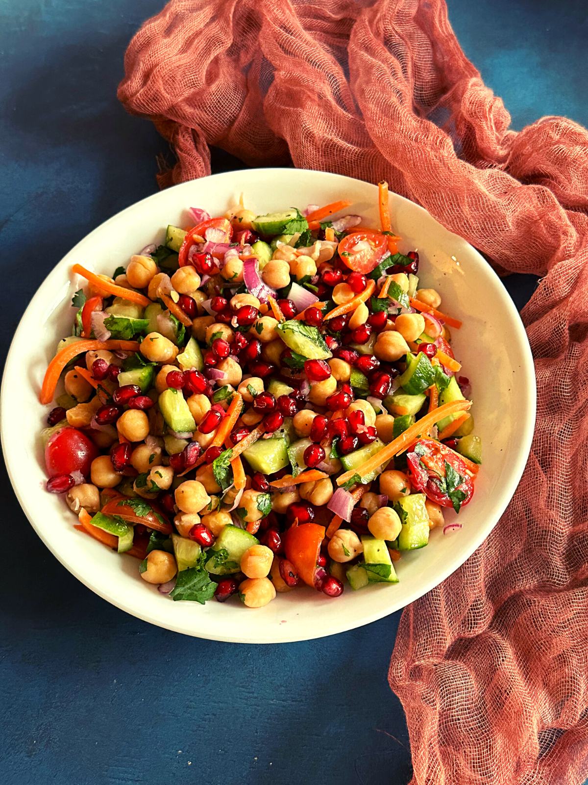 high protein vegetarian salad with chickpeas, veggies and fruits in a bowl