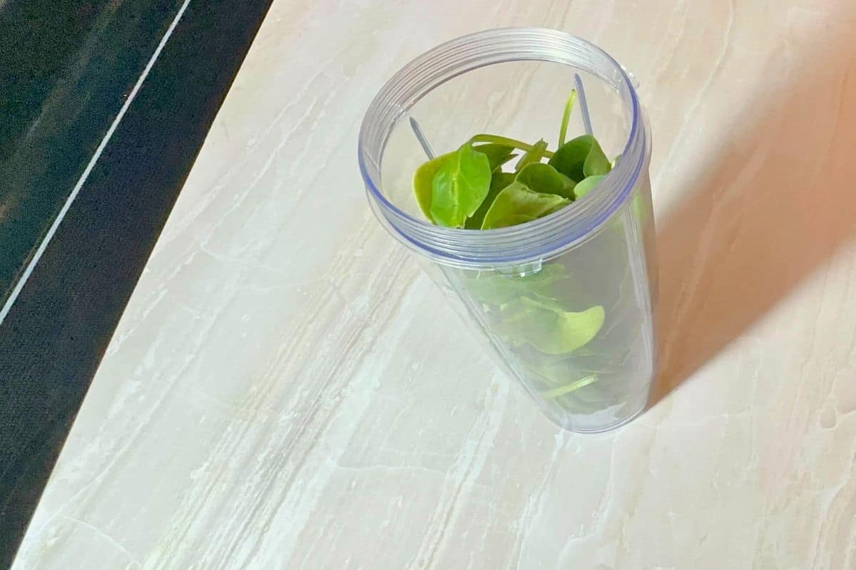 spinach leaves in jar as the main juice ingredient