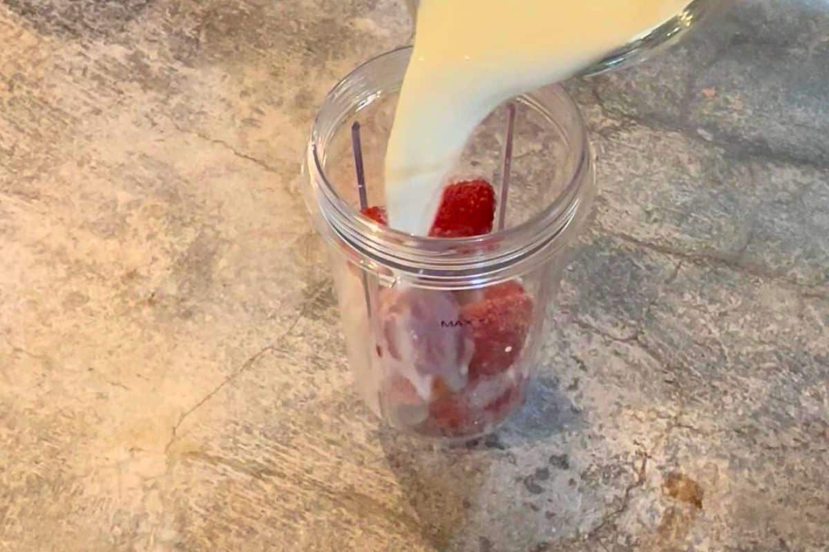 pouring milk into the shake